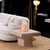 Travertine side table with a rectangular silhouette and substantial stone construction. Made entirely from natural...