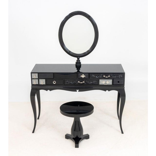 Boca do Lobo "Melrose" Black Lacquered Dressing Table and Stool, the oval mirror above black glass top with eleven drawers...