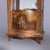 An antique French Louis XIV style vitrine offers Vernis Martin decorated case with shaped crest having central cast...