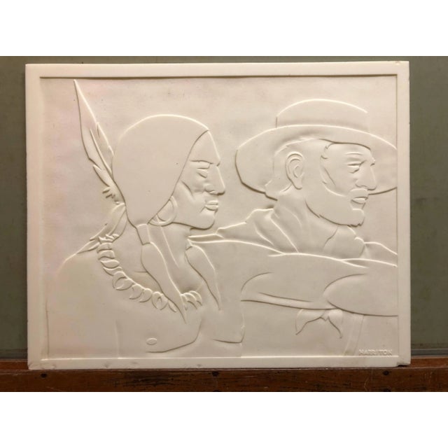 This is a carved glass panel. I belive this is milk glass. it is a classic Americana scene of a cowboy or frontier trapper...