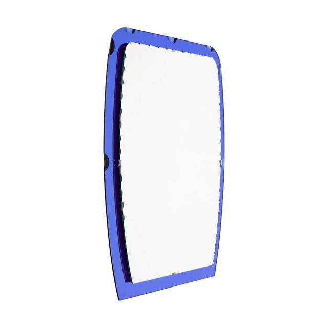 Mirror from modernist period in France. This piece has a frame of blue mirror with a central scalloped mirror, all...