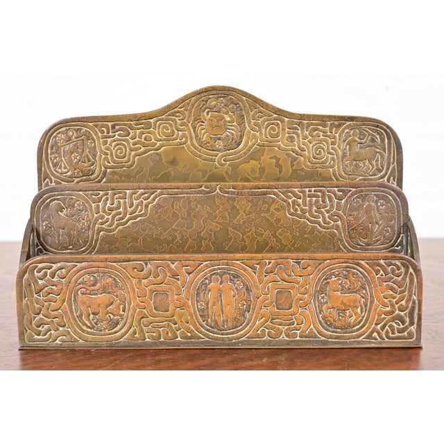 A gorgeous antique Arts & Crafts or Art Deco period bronze desk letter holder rack featuring Zodiac designs By Tiffany...