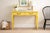 Striking French Provincial writing desk or bedside table, refinished in a bold canary yellow with updated dark bronze...