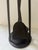 A vintage set of fireplace tools made of wrought iron with brass handles. The set has clean lines and consists of a...