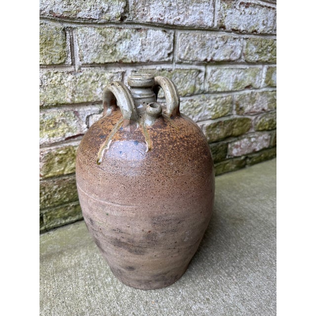 Vintage French jug with two (2) handles and a spout, which was most likely used as a wine pot. Gorgeous texture on the...
