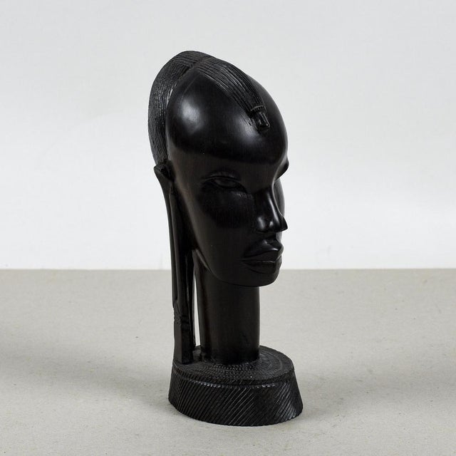 This refined carved female bust, crafted in a vintage african style, represents an example of ethnic art with a powerful...