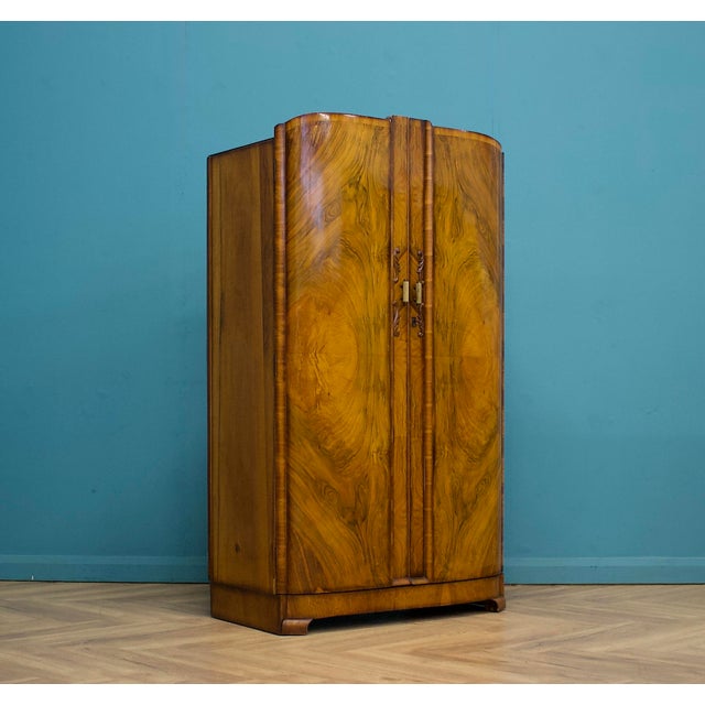 1930s Walnut Two-Door Compact Wardrobe A stylish walnut two-door wardrobe dating to the early–mid 1930s, featuring a...