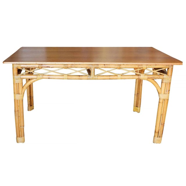 Mid-Century six-person rattan dining table with three pole rattan legs and a solid mahogany table. 1950, United States