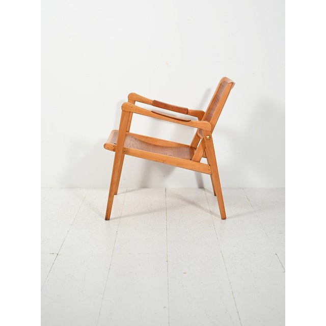 Swedish armchair, model "244," designed by Axel Larsson for Bodafors in the late 1940s, in beech and teak. The model "244"...