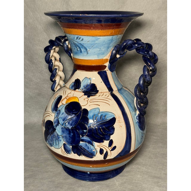 An impressive pitcher with braided handles, hand-painted in cobalt, blue and warm ochre tones. A fine example of...