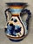 An impressive pitcher with braided handles, hand-painted in cobalt, blue and warm ochre tones. A fine example of...
