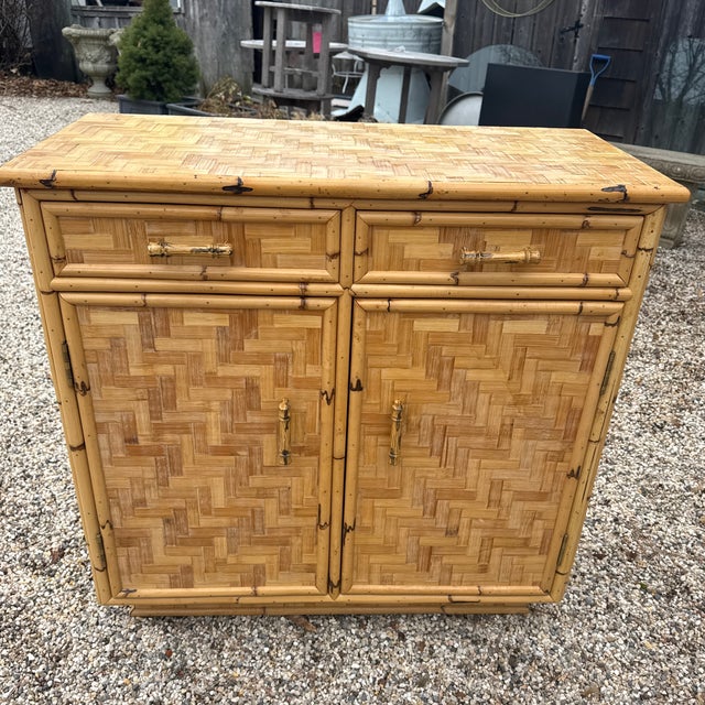 Wonderful vintage woven rattan cabinet with fabulous bamboo handles. A very versatile size - great for an entry, as a bar...