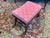 20th century Neoclassical footstool. Wood base upholstered top. Cerule style base with paw foor carved detail.