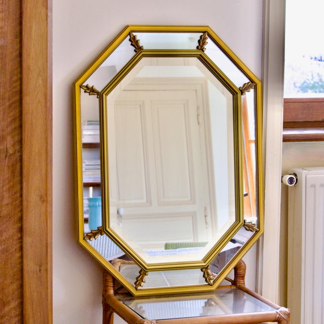 A stunning, large, beveled mirror with a giltwood frame and octagonal shape. This piece combines classic elegance with Art...