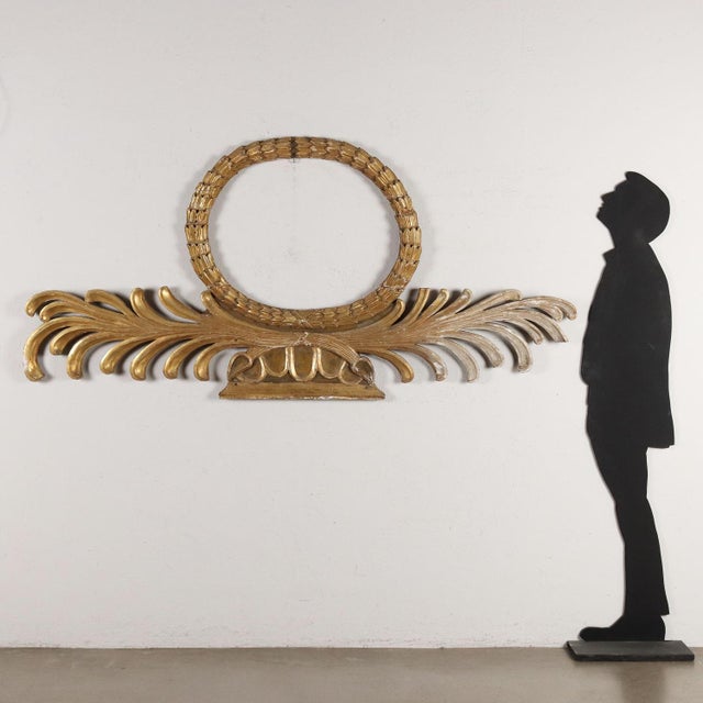 Large upper door frieze in carved and gilded wood, Italy second quarter of the 19th century. Oval upper part depicting a...