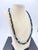 This necklace is a striking example of mid‑century European fine beadwork, pairing ultra-premium Czech faceted jet‑black...