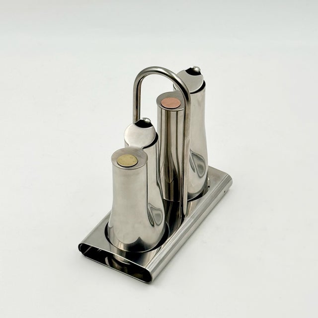 Produced in Italy during the 1970s, this stainless steel condiment ensemble was manufactured by Stella, a brand of...