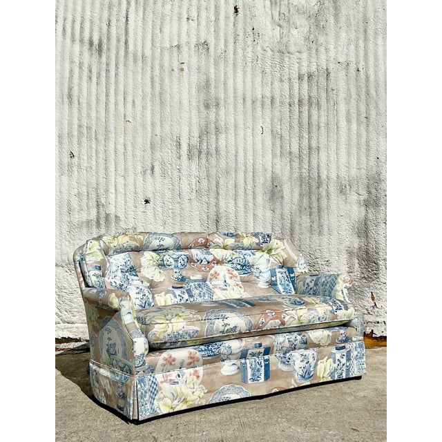 This exquisite vintage Regency loveseat is a true statement piece, upholstered in an eye-catching fabric adorned with an...