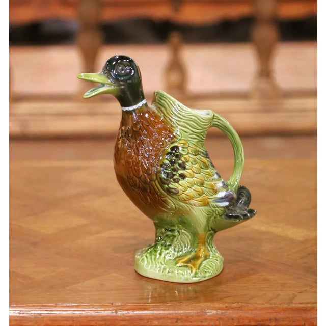 This colorful antique majolica water pitcher was sculpted in France, circa 1960. Hand painted and richly glazed, the...