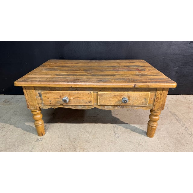 A larger Pine Coffee Table dating to the early 1900s, having 2 drawers to the front and original patina. In overall good...