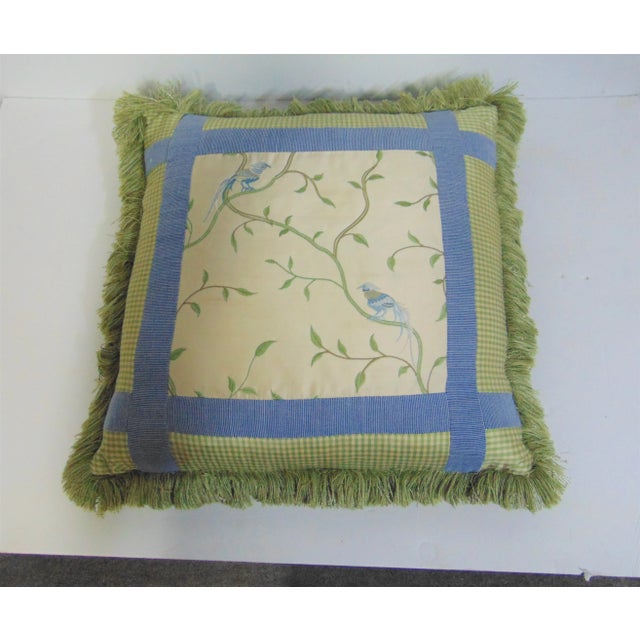 Decorative pillow with embroidered birds on tree limbs, various patterns colors and types of fabric, green shag trim