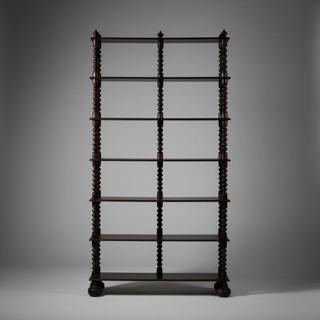 Bobbin-style bookcase. Made in France in 1950, crafted from walnut. Resting on ball feet. In good condition. Dimensions:...