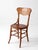 This antique Arts & Crafts oak side chair dates to the early 20th century and features a shaped crest rail with a...