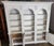 A large two-piece bookcase unit from Pulaski Furniture Co. with a stately neoclassical look. Triple arches, carved wood...
