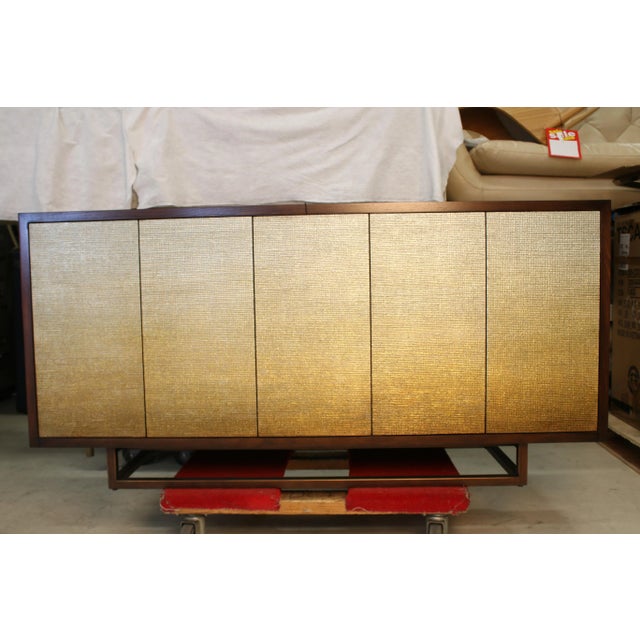A five-door sideboard with three compartments in an American black walnut veneer and a deep, rich finish. The doors...
