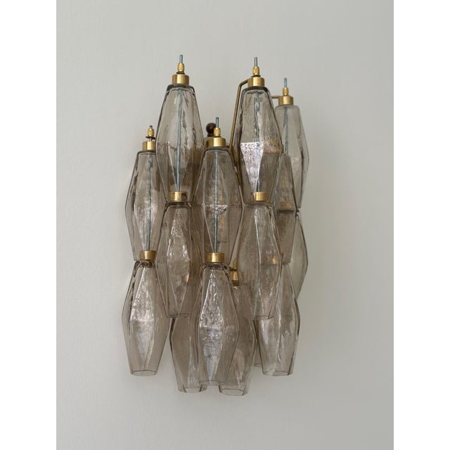 Pair of classic bold eclectic murano wall sconces consisting of 17 handmade crystal prisms in beige colored murano glass....