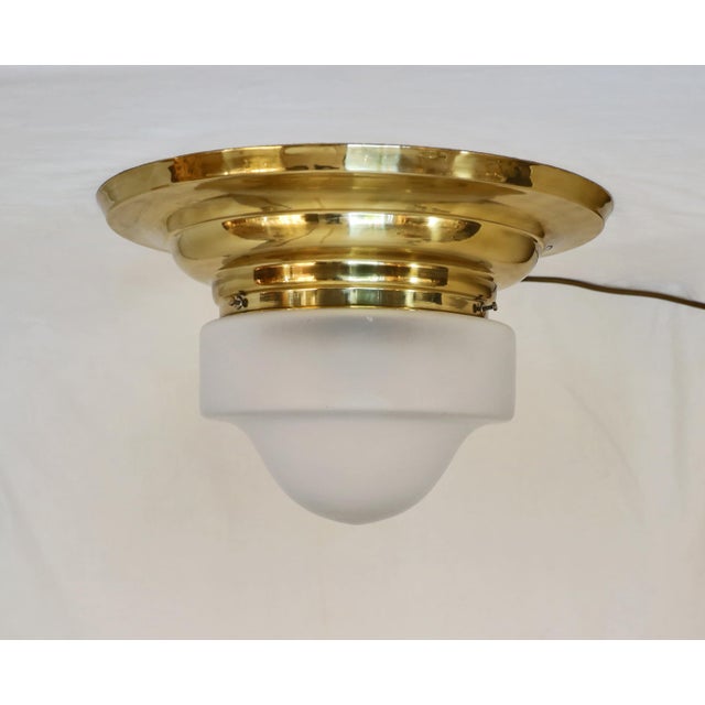 Art Nouveau ceiling lamp, circa 1915. Step-shaped brass body. Original frosted glass shade. The lamp has been completely...