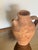 Rustic vintage clay vessel with a charming primitive design, crafted from terracotta with a natural earthy finish. Perfect...