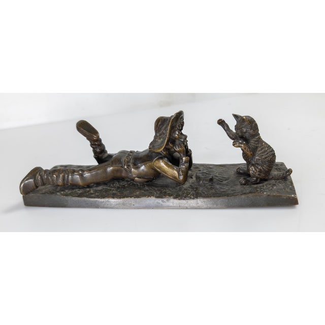 We are selling this charming 19th century Bronze. This bronze features a teenage boy absolutely mesmerized by a playful...