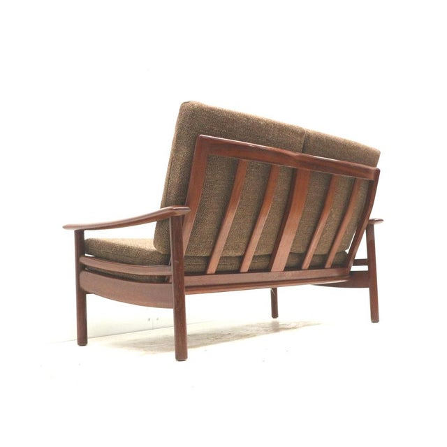 Vintage 2-seater Danish design teak sofa from the 1960s. Stylish vintage 2-seater sofa from Denmark, made in the 1960s and...