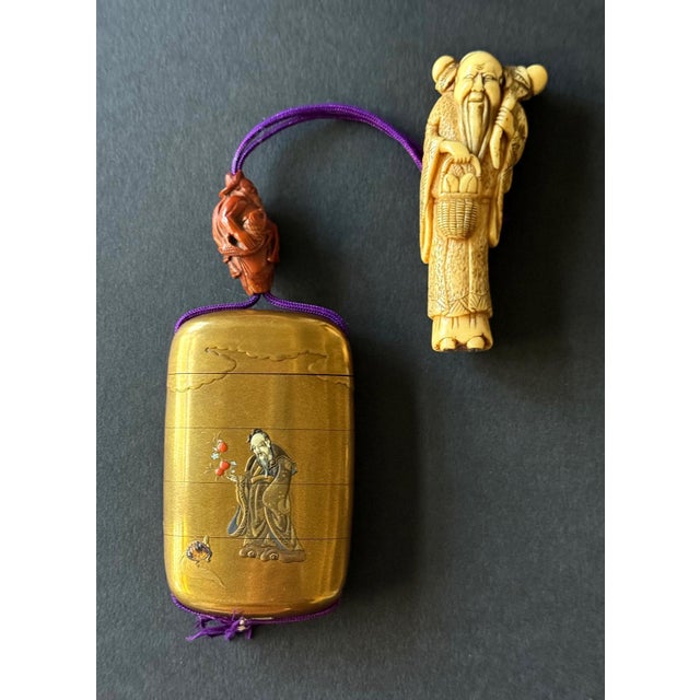 A Japanese four-case inro stringed together with a silk cord of a carved wood Ojime and a carved ivory netsuke circa 19th...