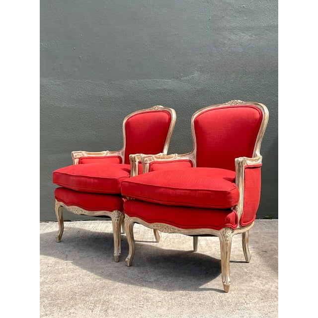 This pair of vintage carved wood bergère chairs brings a refined traditional elegance to any interior, drawing on the...