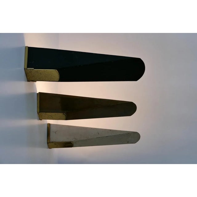 Set of three large and elegant mid-century modern wall lamps or sconces. Designed and manufactured probably in 1950s in...