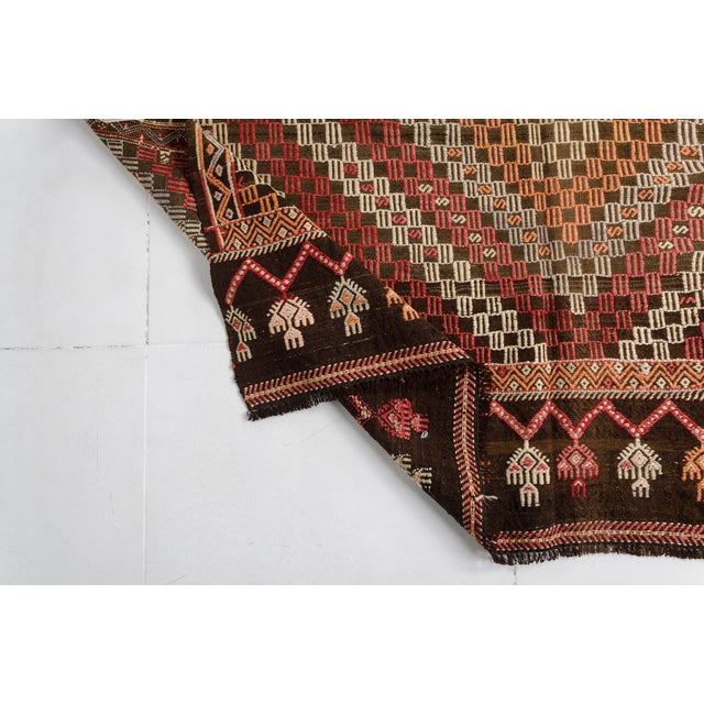 This is a vintage Turkish Oushak rug from the Mid 20th Century. The piece was hand-knotted.