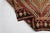 This is a vintage Turkish Oushak rug from the Mid 20th Century. The piece was hand-knotted.