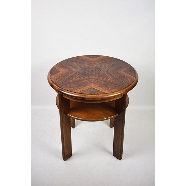 A coffee table from the 1950s, with a distinctly modernist design. The round tabletop with a striking star-shaped...