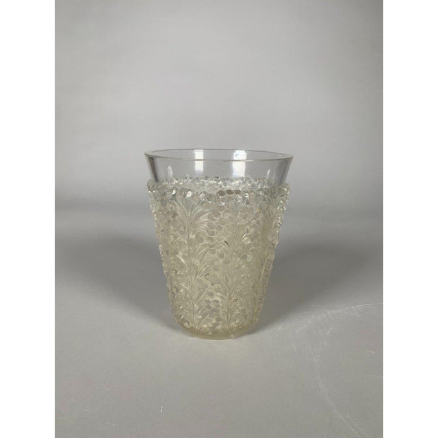 Art Deco pressed glass vase signed René Lalique (1860-1945). "St. Tropez" model . Decorated with stylized mimosa in relief...