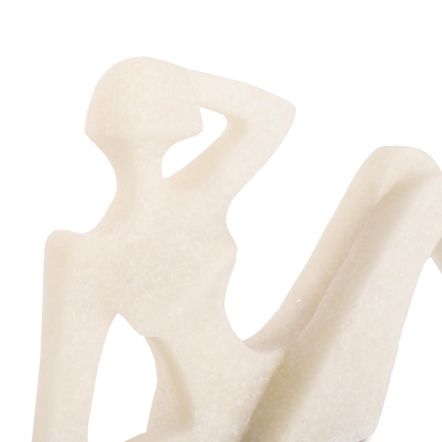 Effortlessly elegant, this Reclining Nude Sculpture features a smooth, abstract silhouette in creamy white stone. A modern...
