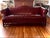 Stately and soulful, this vintage Gunlocke camelback sofa in deep oxblood leather is the kind of piece that anchors a...