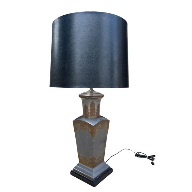 A striking Chinoiserie table lamp with a square, tapered vase-form body in a brushed pewter finish, decorated with applied...