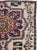 This mid-20th-century Turkish Anatolian throw rug presents two large, vertically aligned floral medallions set against a...