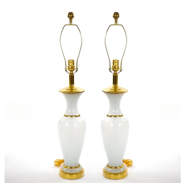 Elegant and glamorous, this pair of opaline glass table lamps embodies the refined aesthetic of Hollywood Regency design....