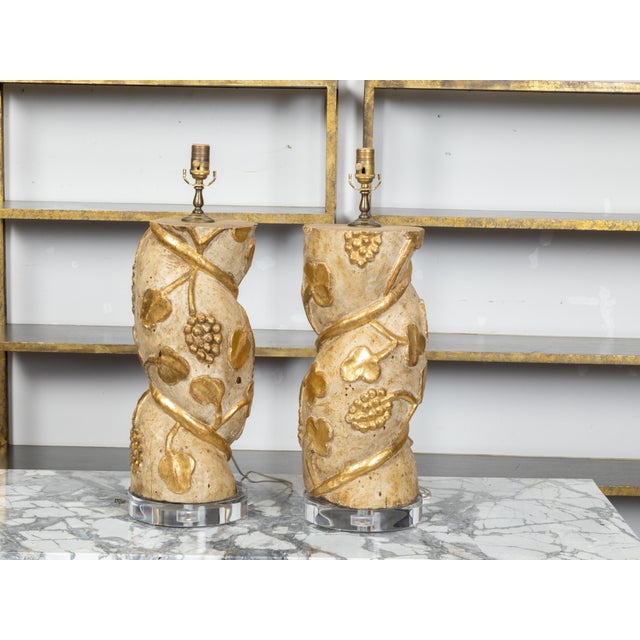 A pair of Italian twisted column wooden fragments from the 18th century, with carved giltwood grapevine motifs and round...