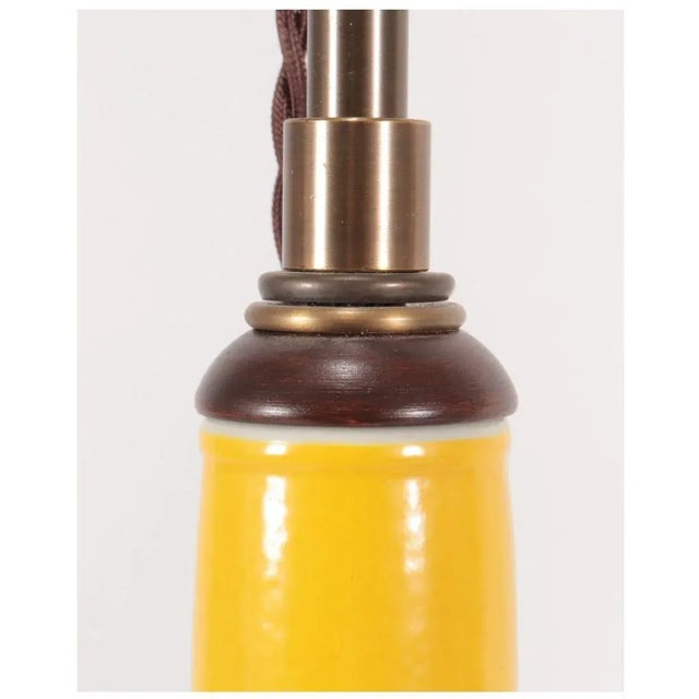 A vintage yellow porcelain gourd lamp with a slender neck and round bottom in a beautiful shade of sunny yellow. Two...