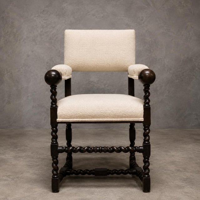 This 19th Century French Louis XIII Oak Arm Chair is a timeless antique seating piece that beautifully blends stately...
