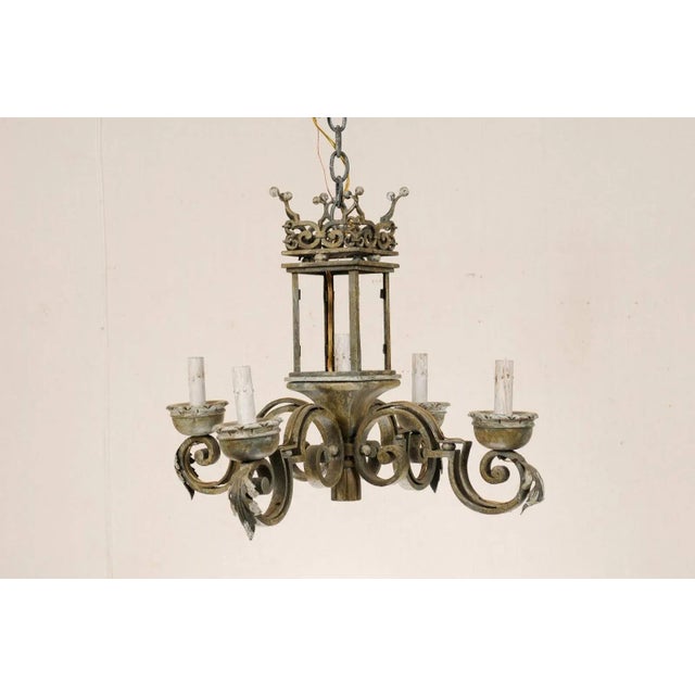 An Italian five-light chandelier. This hand forged Italian chandelier from the mid 20th century has a unique lantern style...